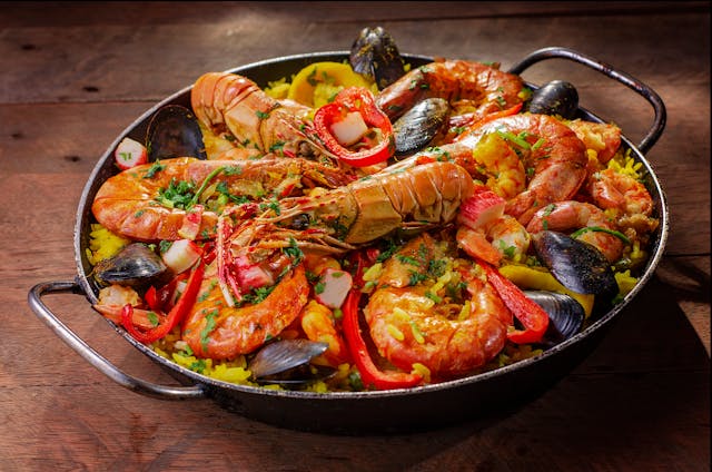 Paella rice with seafood and wine.